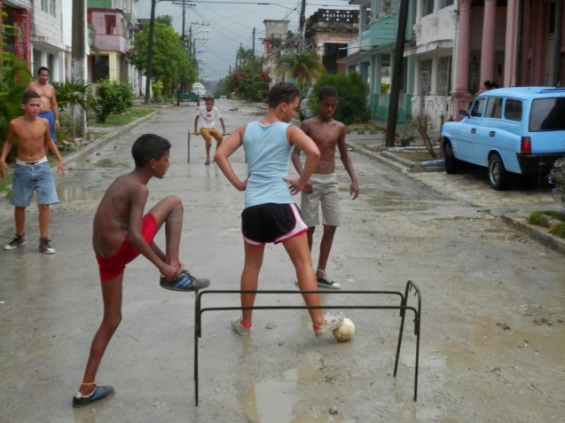 Streets are empty enough for children to play soccer in the middle of the day.